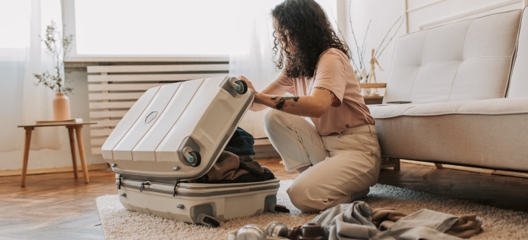 A woman packing a suitcase