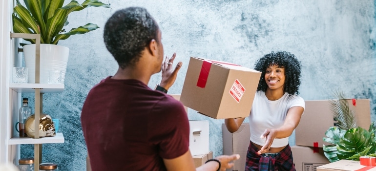 happy couple packing for the move and discussing why people from other parts of Florida move to Miami