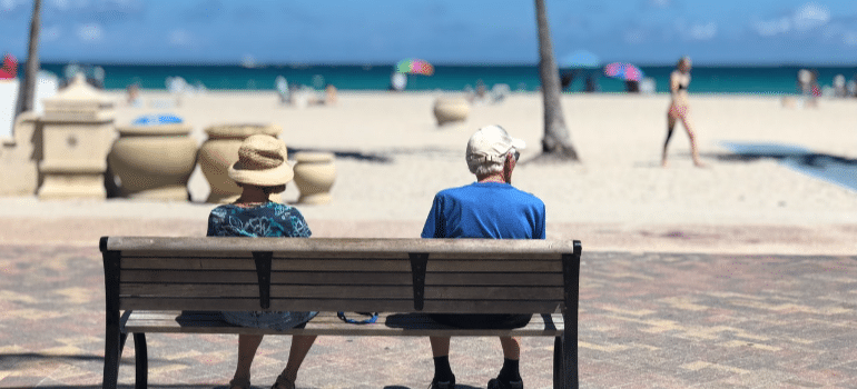 people sitting on a bench and thinking about living near downtown Miami or far from it