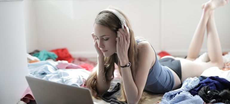 a girl listening to music in a dirty room 