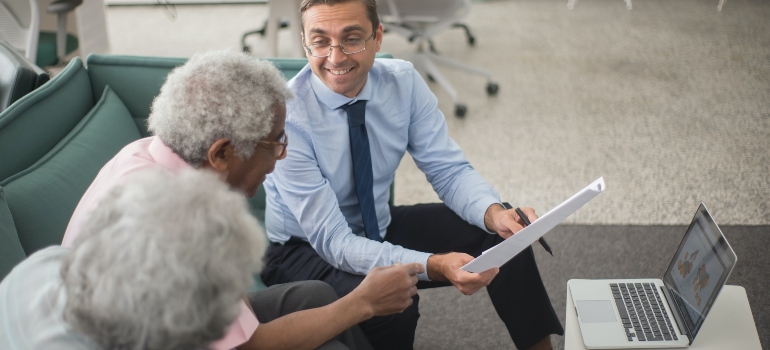 real estate agent discussing with two retirees about buying a retirement property in Florida 