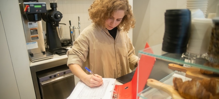 A woman writing an inventory list