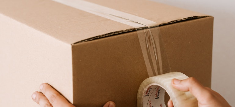 A man taping a box 