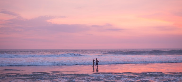 people on a beach in Boca Raton thinking about buying vacation home in Boca Raton