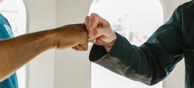 Men greeting each other with fists