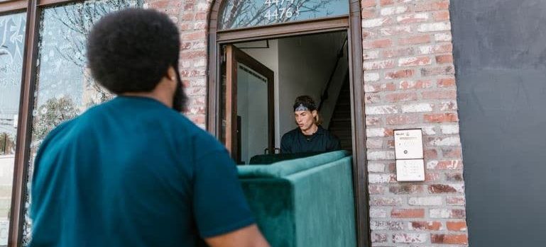Movers lifting heavy furniture