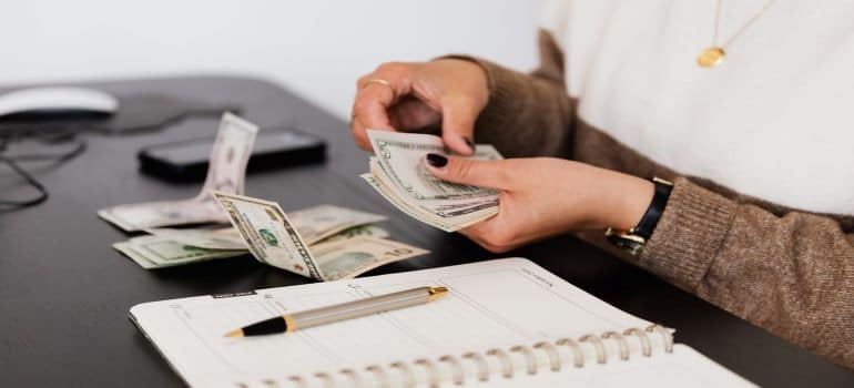 A woman counting money for relocation