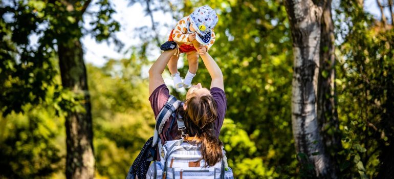 Woman carrying a bag for organizing an interstate move with toddlers