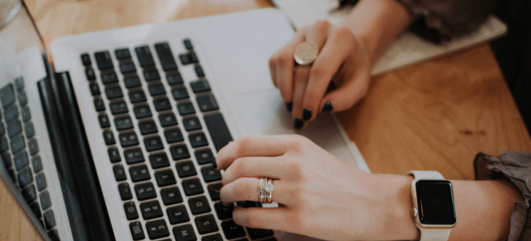 a woman reading on the laptop and trying to local Florida relocation this spring