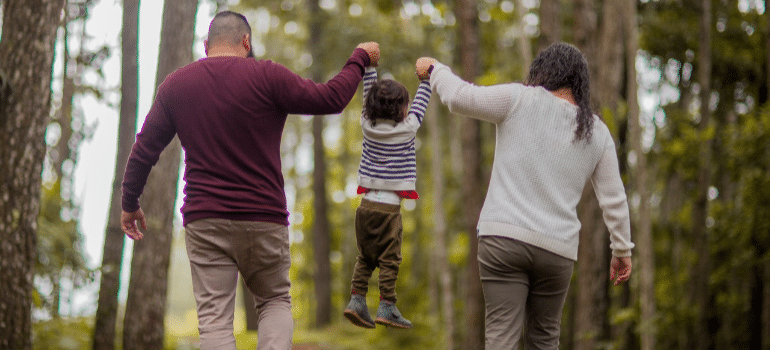 people taking a child by the hand