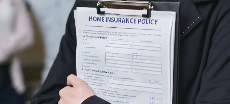 a person holdinh home insurance policy document