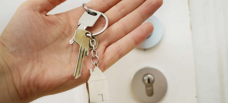 someone holding keys in front of a door