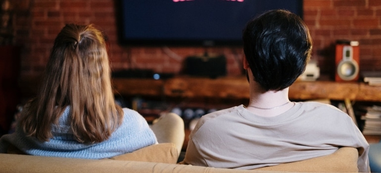 People Sitting on a Couch Watching