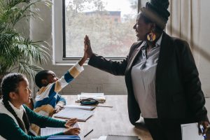 Teacher giving high-five to student