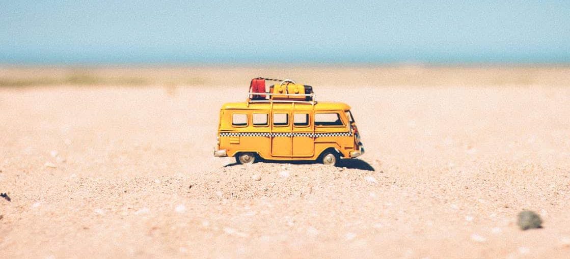 A van toy on sand