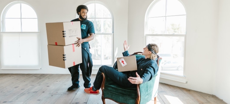 Wynwood movers holding boxes and talking