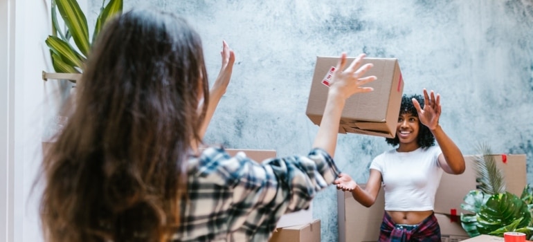 girls happy they are moving with the help of Grapeland Heights movers