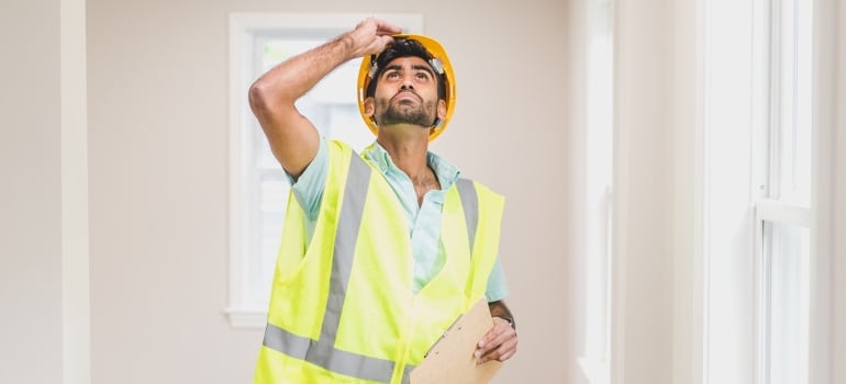 A Man Inspecting the House Interior