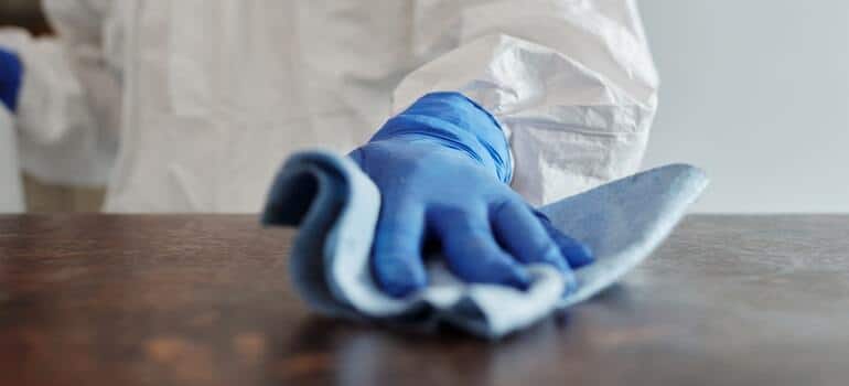 A person cleaning a table