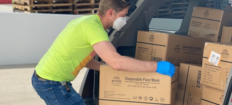 A man pulling a box from a moving van