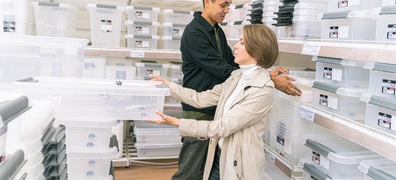 Couple choosing plastic boxes