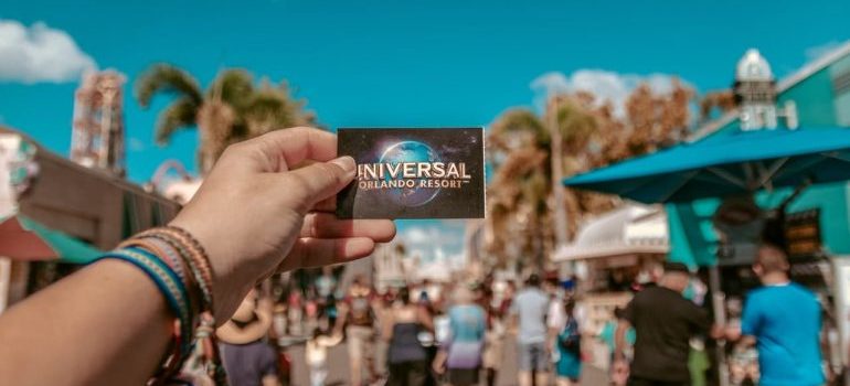Person holding Universal studio ticket in Orlando, one of the best places to buy investment properties in