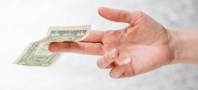 A hand holding a dollar.
