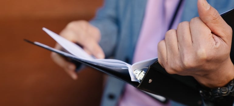 A man holding a binder