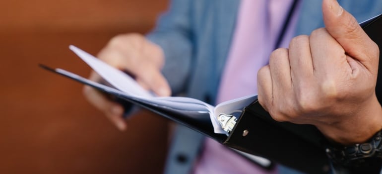 A man holding a binder