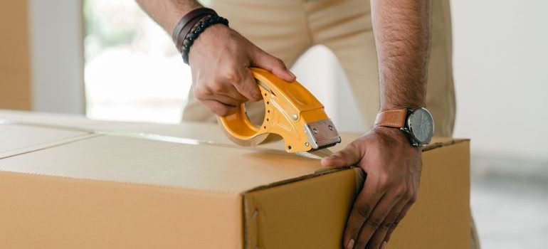 a man taping a box