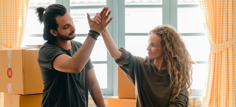 couple high fiving and talking about finding a good rental apartment in Florida