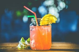 a jar with cocktail and lemon