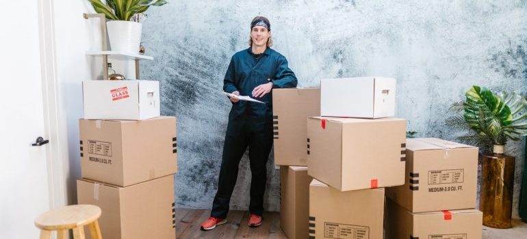 Professional mover surrounded by boxes