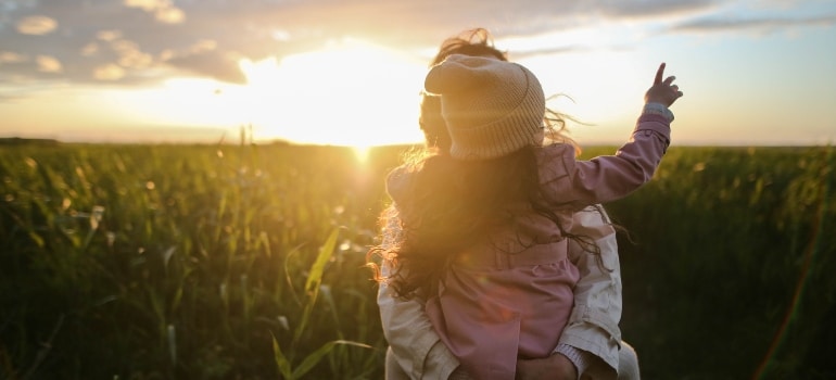 mom and daughter enjoying the sunset