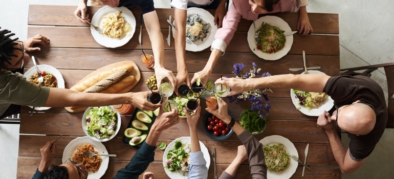 a group of friends having dinner at the big table