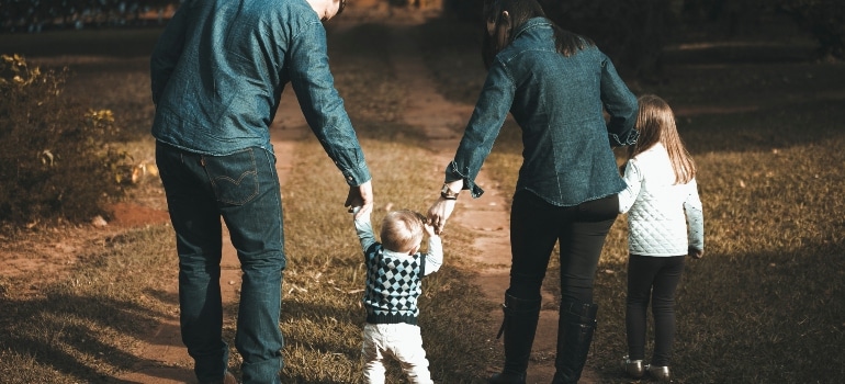 parents walking with their kids down the path