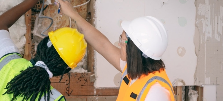 two female home inspectors ensuring everything is in good condition before one should want to buy a home in Broward County, FL