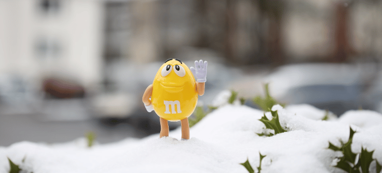 a yellow toy on the snow