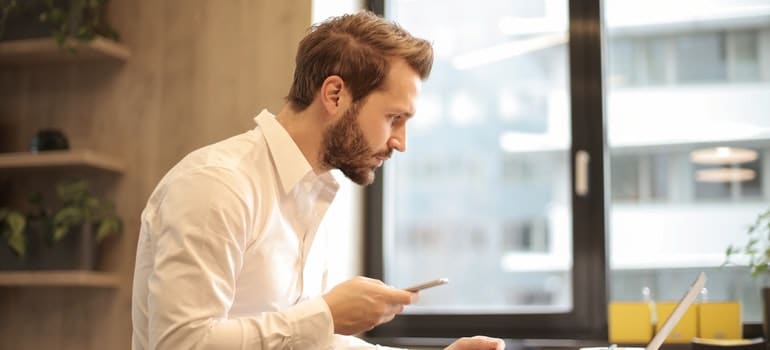 a man looking at a laptop trying to buy a vacation home in southeastern Florida