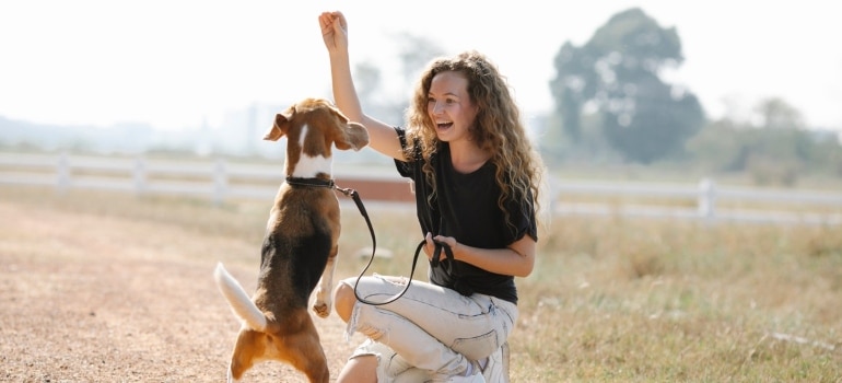 A woman playing with her dog representing reasons to move to Boca Raton with your pet