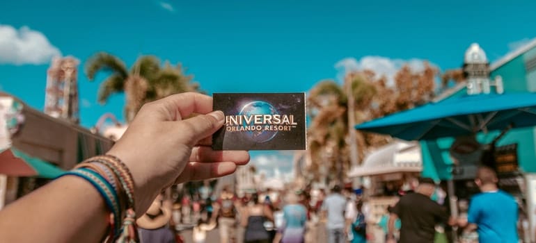 a hand holding a Universal ticket