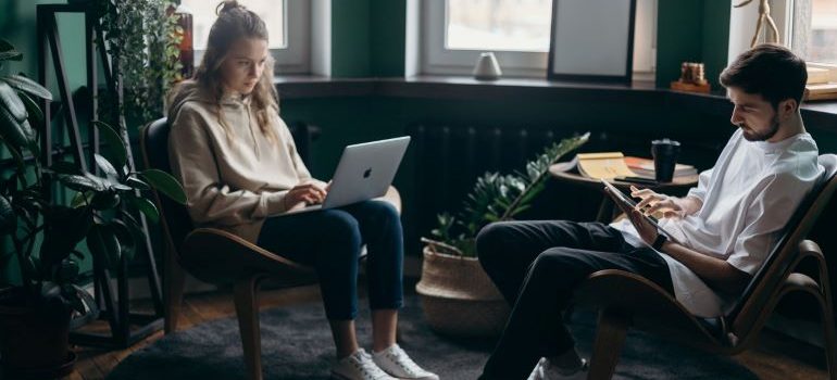 two people using laptops