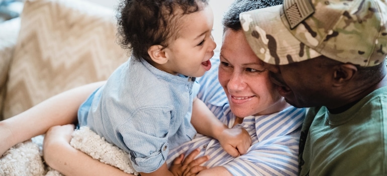 parents playing with their child after choosing among best places in Florida military families love