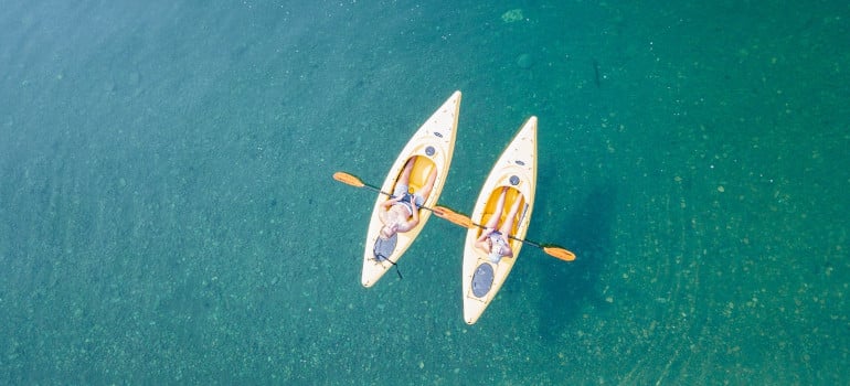 Birds eye view of two people canoeing on body of water