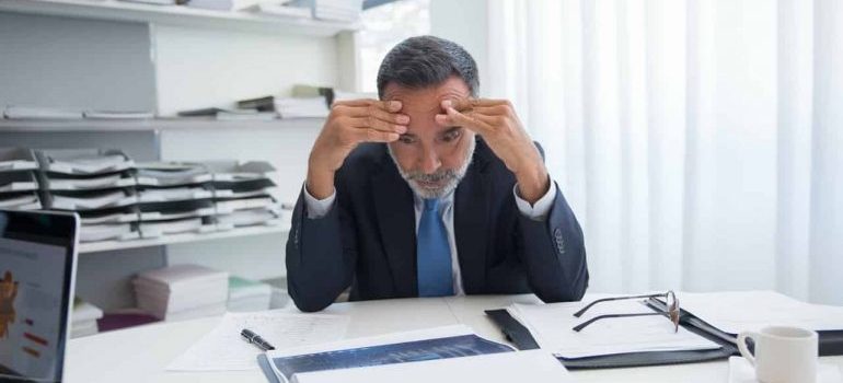 Man with his hands on his head trying to choose between Boca Raton vs Fort Lauderdale for his office