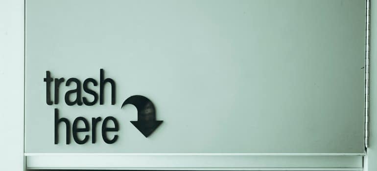  trash here letters on a blue surface