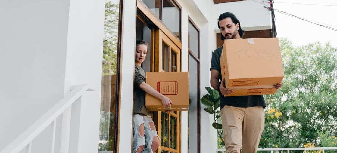 A couple carrying boxes