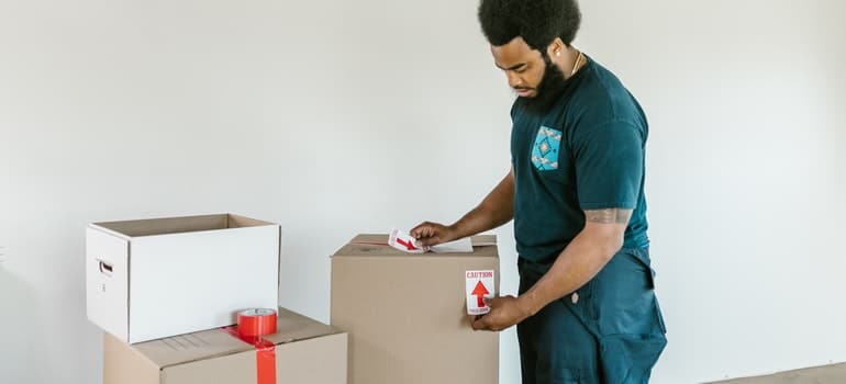 a labelling a box to organize green relocation to Fort Lauderdale