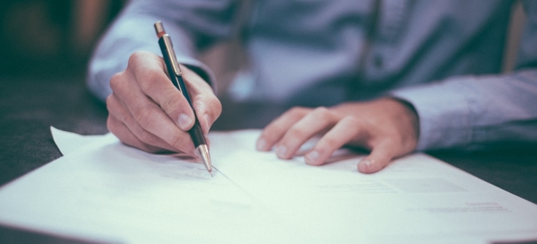 A man signing a contract.