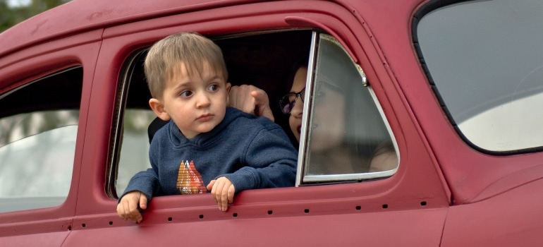 A child in a car with his mother